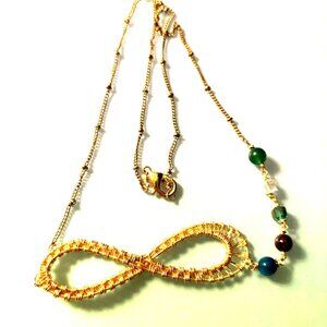 Infinity wrapped pendant on yellow gold plated chain